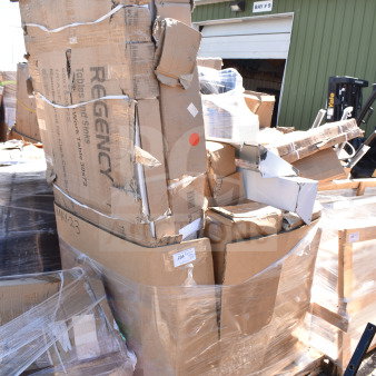 Stack of new items with scratch and dent, including table base columns and legs, wrapped in boxes. Regency branding visible.