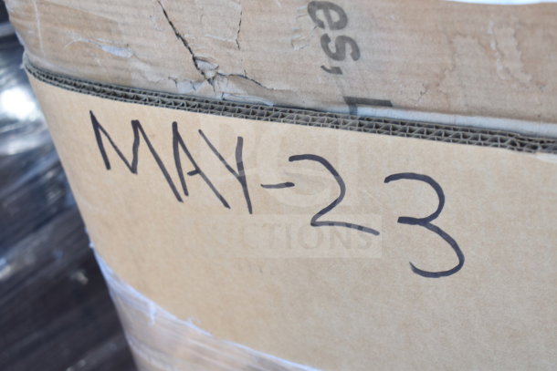 Cardboard box marked "MAY-23," containing 15 new scratch and dent items, including table base columns, legs, and a faucet.