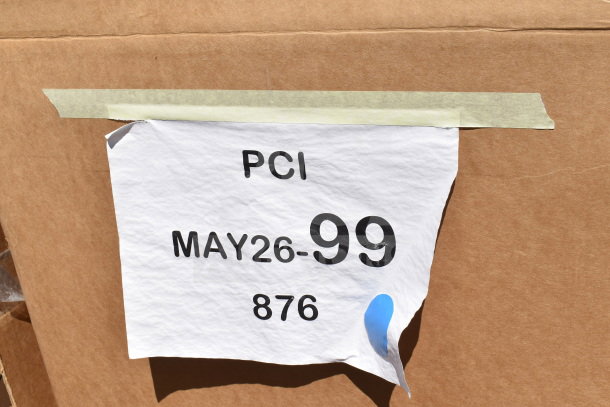 Cardboard box with a white label marked "PCI MAY26-99 876," indicating item identification for auction logistics.