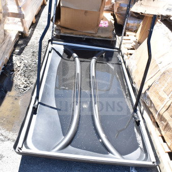 Brand new black unit with minor scratches and dents, frame structure visible, surrounded by boxed pallets, ready for use.