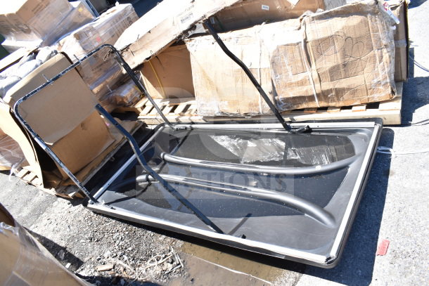 BRAND NEW SCRATCH AND DENT black unit on the ground, slight scratches visible; open cardboard boxes behind.