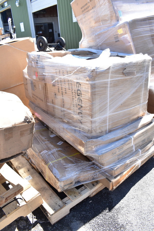 Sealed pallets of assorted scratch and dent items, including a mop sink and liquor display rack, in boxes on a wooden pallet.