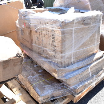 Sealed pallets of assorted scratch and dent items, including a mop sink and liquor display rack, in boxes on a wooden pallet.