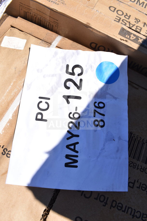 Label reading "PCI MAY26-125 876" on a box containing 7 brand new scratch and dent items, including a mop sink and liquor display rack.