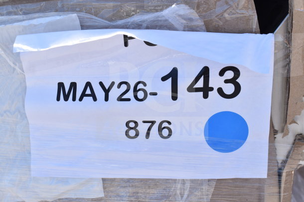 Label on a package marked "MAY26-143" and "876" with a blue dot, indicating a scratch and dent auction lot.