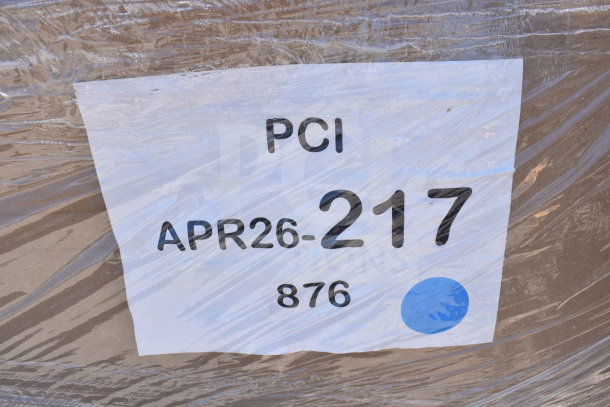 Plastic-wrapped package with a label marked "PCI" and "APR26-217," indicating auction items including chairs.