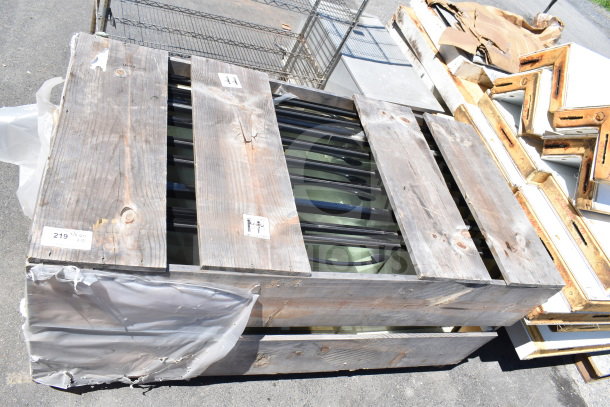 10 brand new scratch and dent doors in wooden crates, labeled 219, sold at auction with potential for high return.