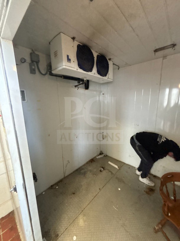 Master-Bilt 8'x12' walk-in box with compressor and evaporator fan. Interior view shows mounted fan unit; visible wear on flooring.