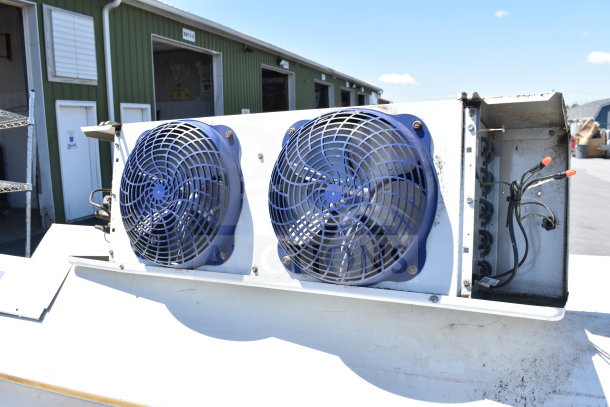 Master-Bilt 8'x12' walk-in box unit with compressor and evaporator fan, featuring blue fan covers; outdoor view.
