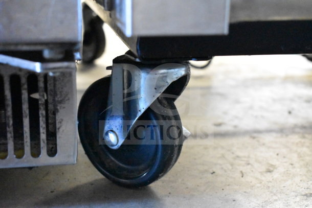 2021 True T-35-HC cooler on commercial casters, 2-door, 115V, 1 phase. Close-up of caster wheel, in good condition.