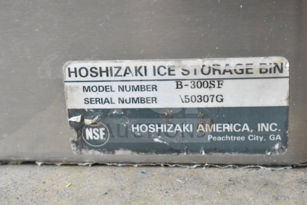 Hoshizaki ice storage bin with model number B-300SF. Label shows wear. Located in Peachtree City, GA.