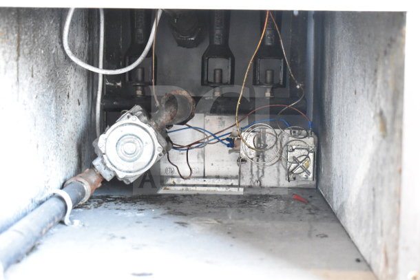 Bakers Pride gas-powered deep fat fryer interior showing control components and wiring. Visible signs of use.