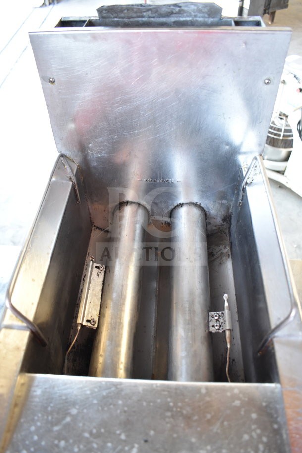 Commercial countertop gas-powered deep fat fryer with stainless steel construction, showing heating elements and interior components.
