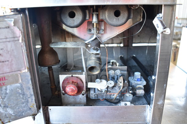 Commercial countertop gas deep fat fryer, showing internal components, control knobs, and connections. Used condition.