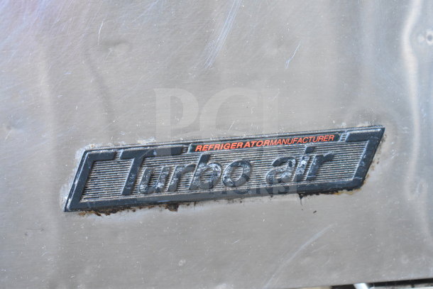 Turbo Air TUR-36SD undercounter cooler nameplate, showing brand and model details. Visible wear around edges.