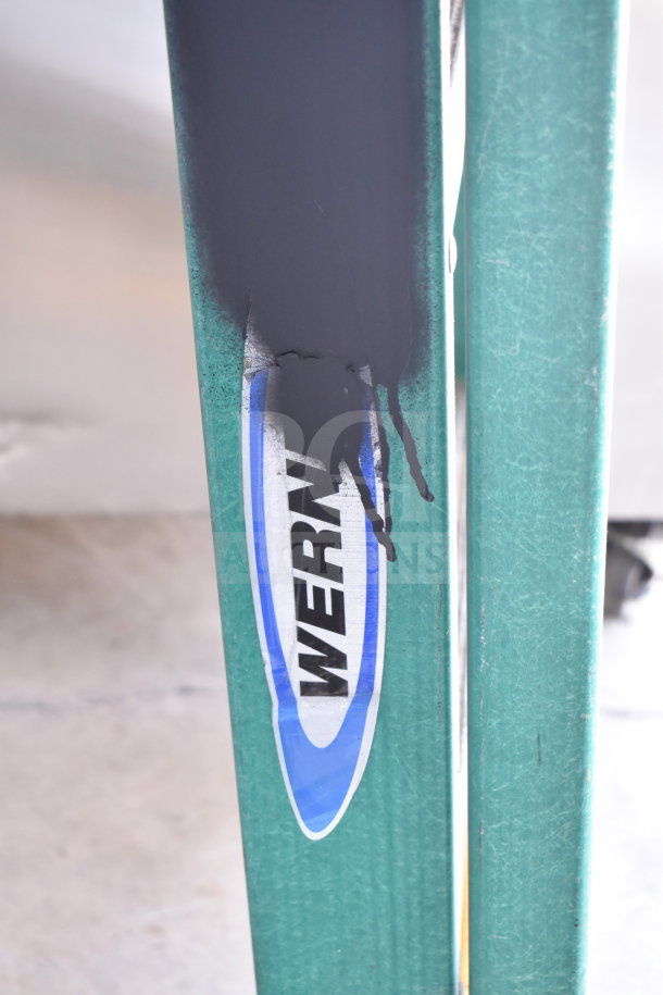 Close-up of a Werner ladder with paint marks on a green metal rung, part of a set of four ladders in the auction.