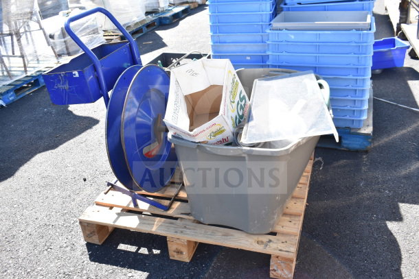 Pallet lot with banding station, cords, storage bins, and boxes, used condition. Ideal for industrial use.