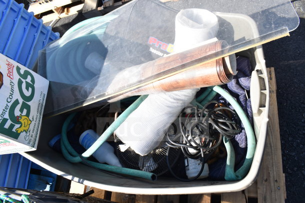 Pallet lot featuring various items, including a banding station, cords, hoses, and packaging materials. Mixed condition.