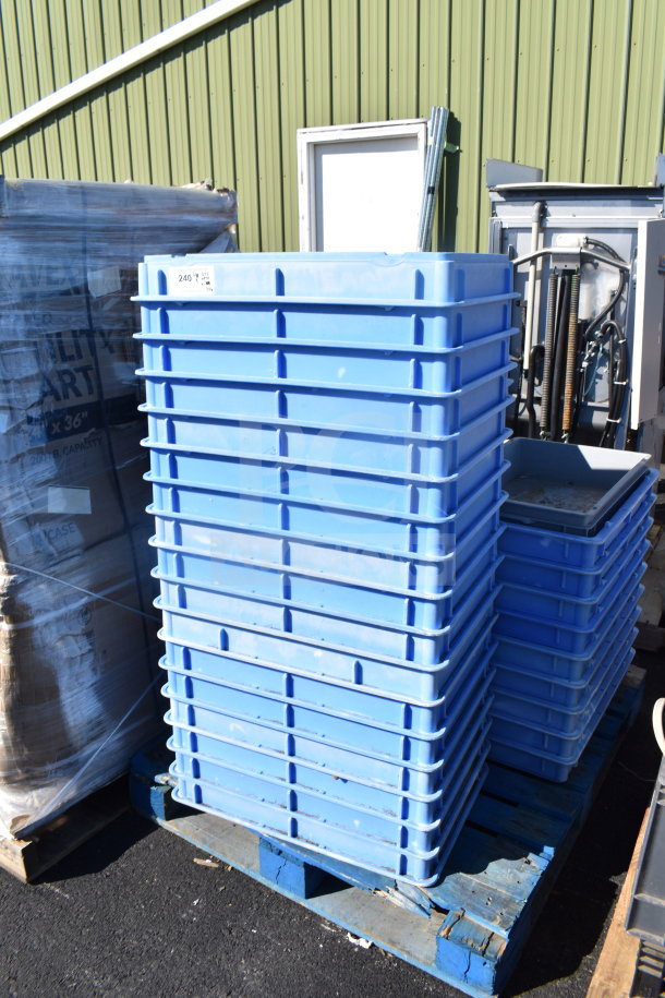 Stack of blue poly dough bins on a pallet, in used condition, alongside other assorted items for auction.