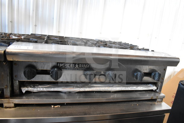 American Range commercial countertop gas-powered 6 burner range, with visible control knobs and brand label, in used condition.