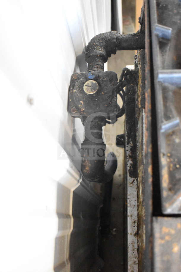 American Range commercial countertop gas-powered 6 burner range, visible gas line connection, shows signs of wear.