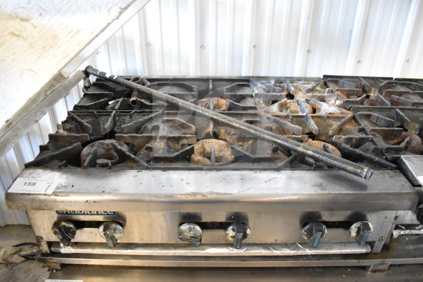 Radiance commercial countertop gas-powered 6 burner range, showing signs of use with some rust and wear.