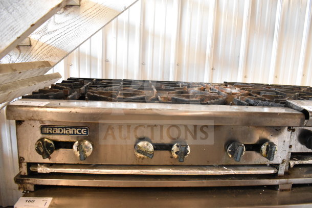 Radiance commercial countertop 6-burner gas range, stainless steel, visible wear, functional knobs, ideal for professional kitchens.