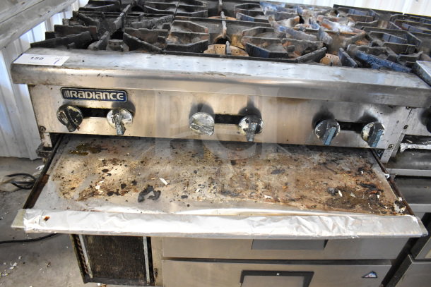 Radiance commercial countertop gas-powered 6 burner range, stainless steel, well-used, visible wear and grime, burner knobs intact.