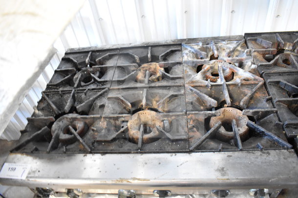 Radiance 6 burner gas range, commercial countertop model. Used condition with visible wear and residue on burners.