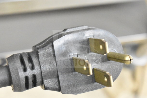 Close-up of a three-prong plug for a Blodgett CTB-1 commercial convection oven, compatible with 208-240 volts, 1/3 phase.