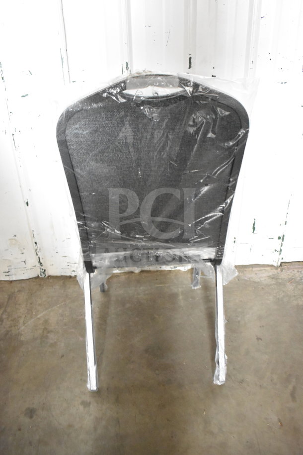 Brand new scratch and dent Lancaster Table & Seating Crown Back Stackable Banquet Chair with gray fabric and silver vein frame.