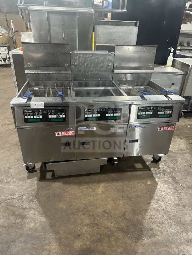 Pitco Solstice SSH75 stainless steel triple bay deep fryer on casters, with backsplash and baskets, 115V, natural gas powered.