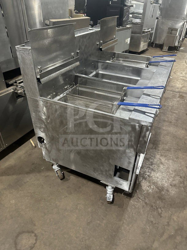 Pitco Solstice Supreme SSH75 commercial stainless steel triple bay fryer with backsplash, baskets, and casters; natural gas-powered.