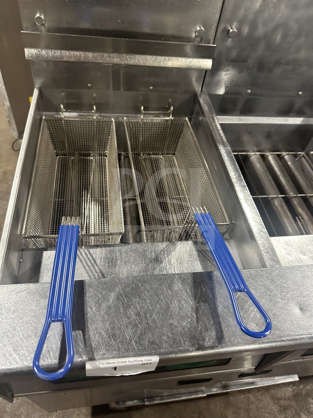 Pitco Solstice Supreme SSH75 triple bay deep fat fryer with blue-handled basket, backsplash, and casters. Stainless steel.