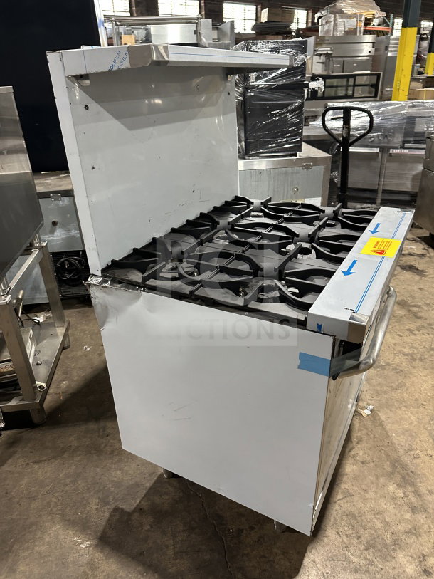 Brand new Kutano 36" 6-burner stainless steel gas range/oven, model KUT-6-BR-N-36-N6, with scratches, on legs.