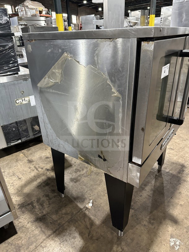 Southbend commercial stainless steel gas convection oven, single stacked, Energy Star certified, thermostatic controls, wired rack, on legs, visible wear on exterior.