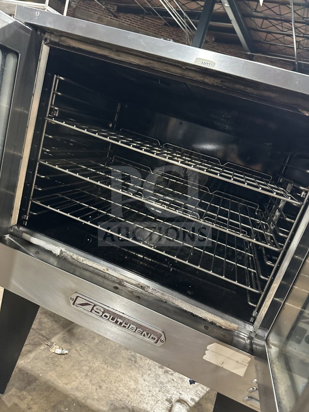 Southbend stainless steel gas convection oven with wired rack, Energy Star certified, thermostatic controls, on legs, open door.