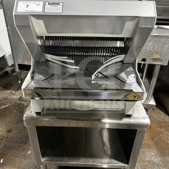 JAC Pico MJL 450/13 electric bread slicer, heavy-duty, countertop model, silver finish, on legs, warning label visible, used condition.