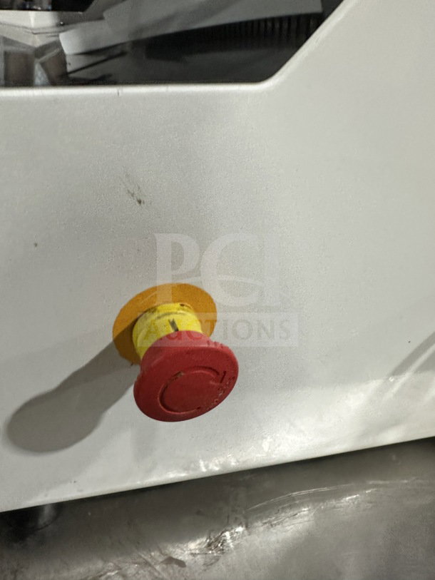Red emergency stop button on JAC Pico MJL 450/13 heavy-duty electric bread slicer.