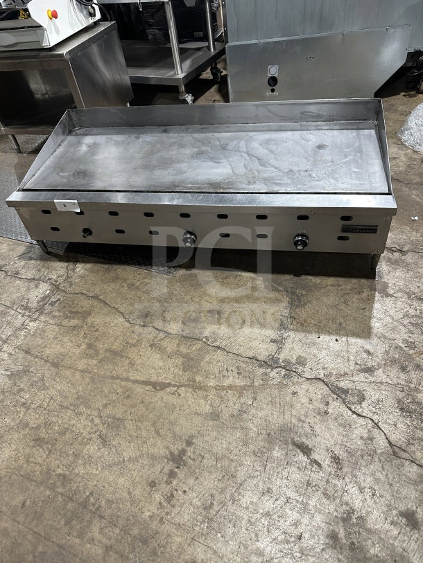 Garland Commercial Stainless Steel Countertop Gas Griddle, Model 60.5, on legs, good condition, three burner knobs.