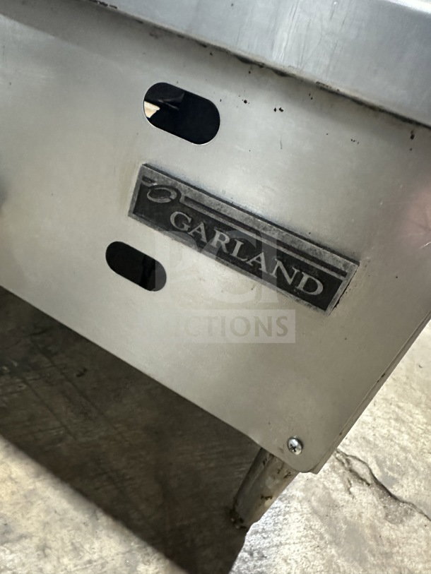 Garland Model 60.5 stainless steel countertop gas griddle, on legs, commercial-grade, good condition, visible branding tag.