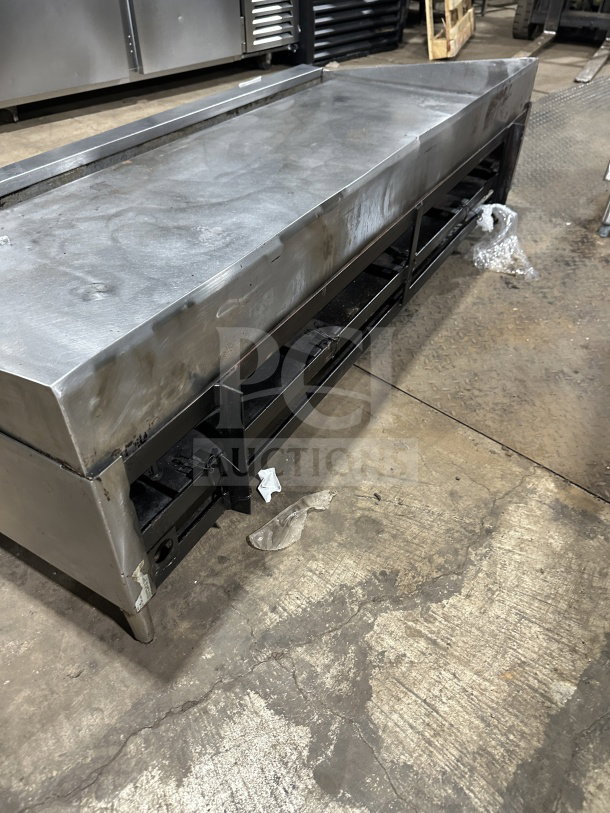 Garland commercial stainless steel countertop gas griddle, model 60.5, on legs. Used condition with visible wear.