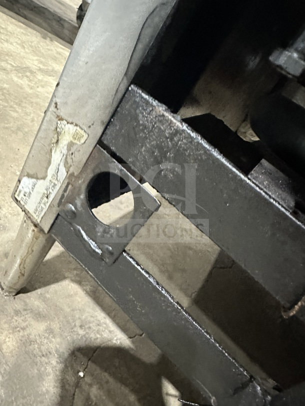Garland Commercial Stainless Steel Gas Griddle, model 60.5, on legs, visible wear on metal frame, partial label.