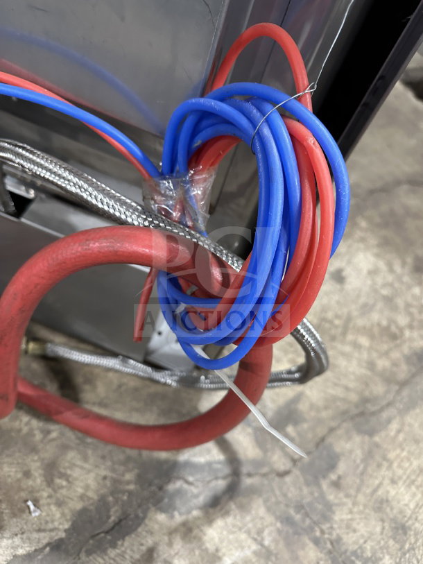 Coiled red and blue electrical cords attached to Hobart Advansys LXe Series dishwasher, model LXER.