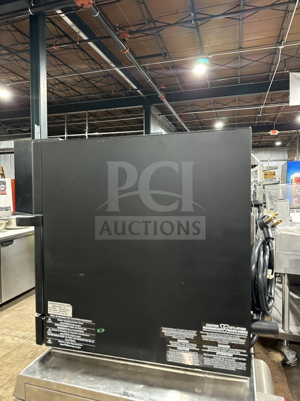 MerryChef Eikon E2S commercial rapid cook oven, black, electric-powered, excellent condition, visible safety labels and power cord.