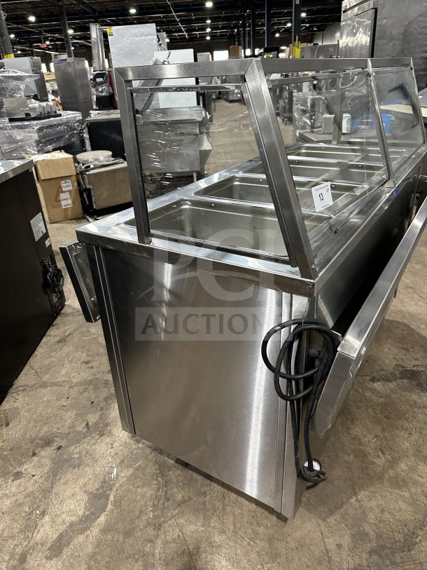 Randell RANHTD4S stainless steel 4-well electric steam table with sneeze guard and 2-shelf storage, on casters. 120V.
