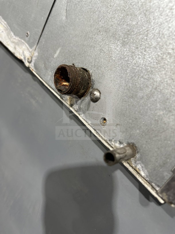 Hoshizaki KM515MAH ice machine detail showing rusted threaded pipe connection; stainless steel body.