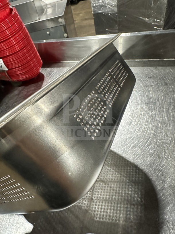 New commercial stainless steel perforated full-size steam table pan, excellent condition, smooth finish, stackable design.
