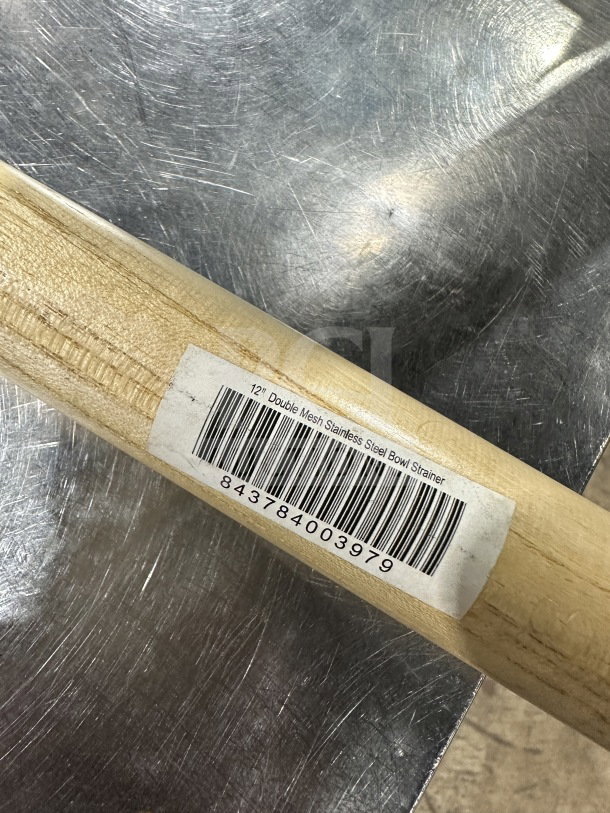 Brand new 12" double mesh stainless steel bowl strainer in original packaging, showing label with barcode 843784003979.