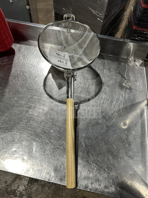Brand new 12" commercial-grade double mesh stainless steel bowl strainer with a wooden handle, pristine condition.